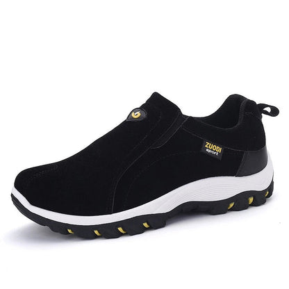 Black slip-on shoes with white sole on a white background