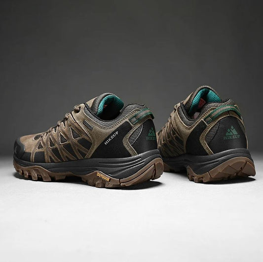 Pair of hiking shoes with visible brand logo on a dark background