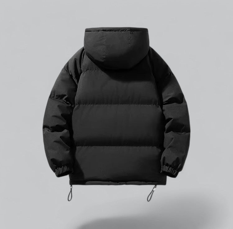Black puffer jacket on a gray background