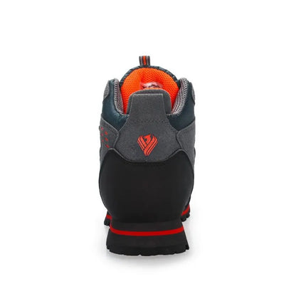 Back view of a gray and black glove with red accents on a white background