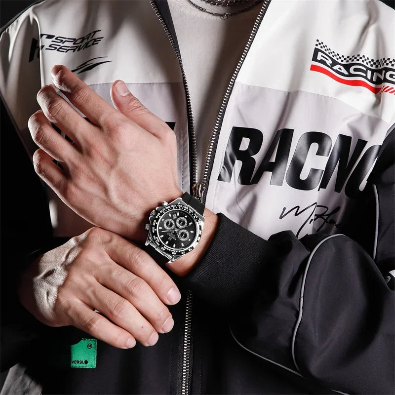 Person wearing a racing-themed jacket with a watch on their wrist.