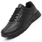 Black sneaker with visible brand logo on a white background
