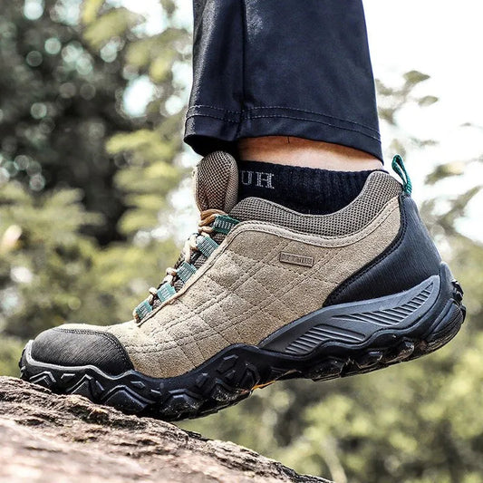 Hiking boot on a rock with a blurred natural background
