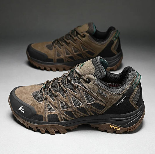 Pair of brown hiking shoes on a gray background