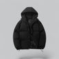 Black puffer jacket with a hood on a light gray background