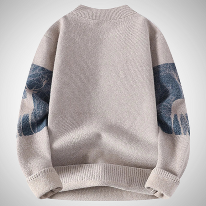 Gray sweater with blue arm patches on a light gray background