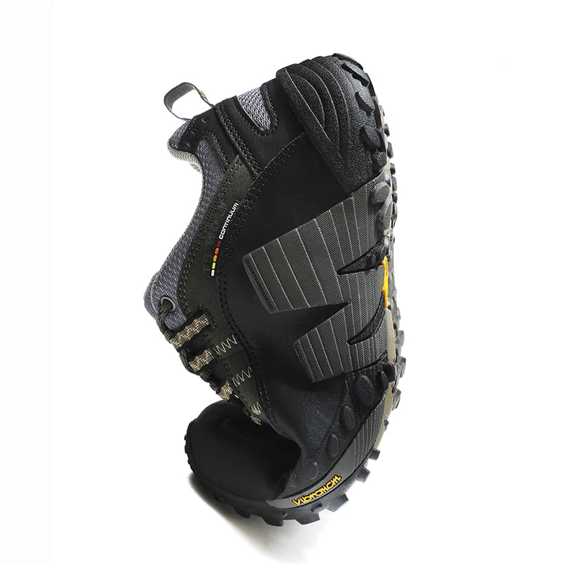 Black hiking boot with tread pattern on a white background