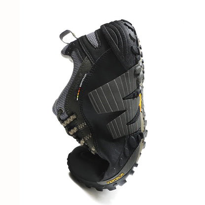 Black hiking boot with tread pattern on a white background
