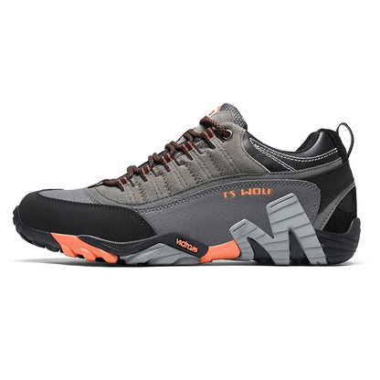 Gray and black athletic shoe with orange accents on a white background
