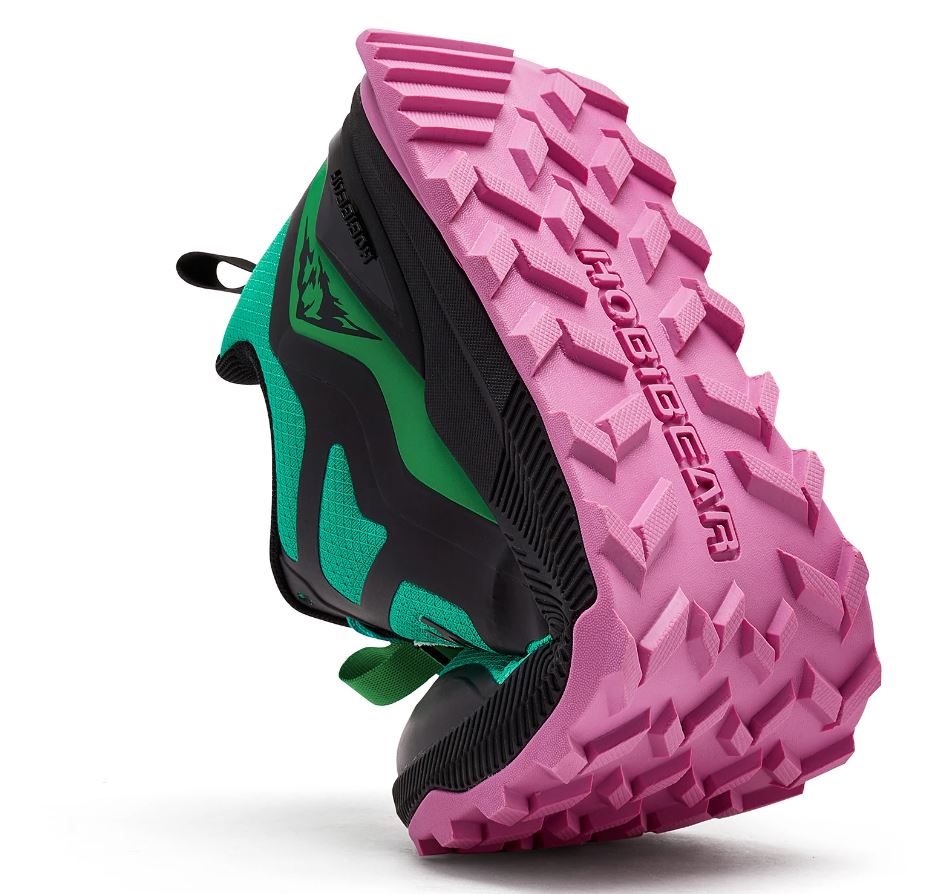 Trail running shoe with pink sole on a white background