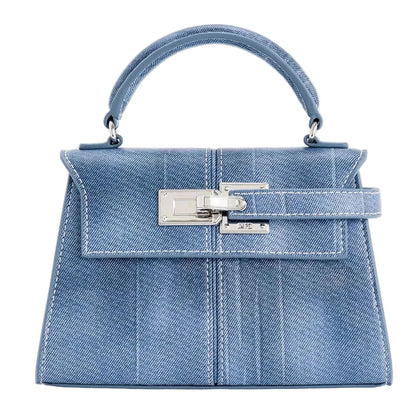 Blue denim handbag with silver hardware on a white background