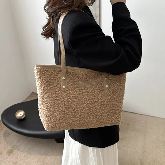 Person holding a brown textured tote bag against a neutral background