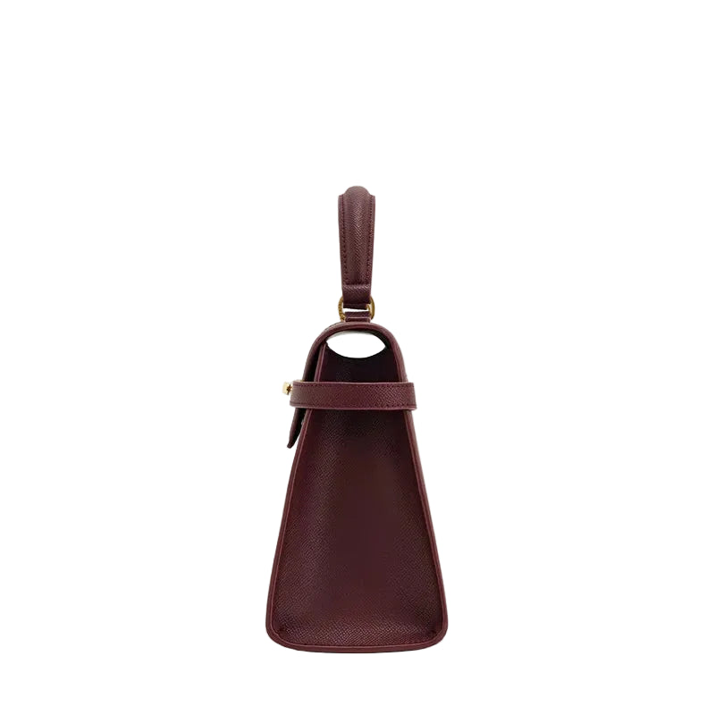 Brown leather handbag with a strap on a white background