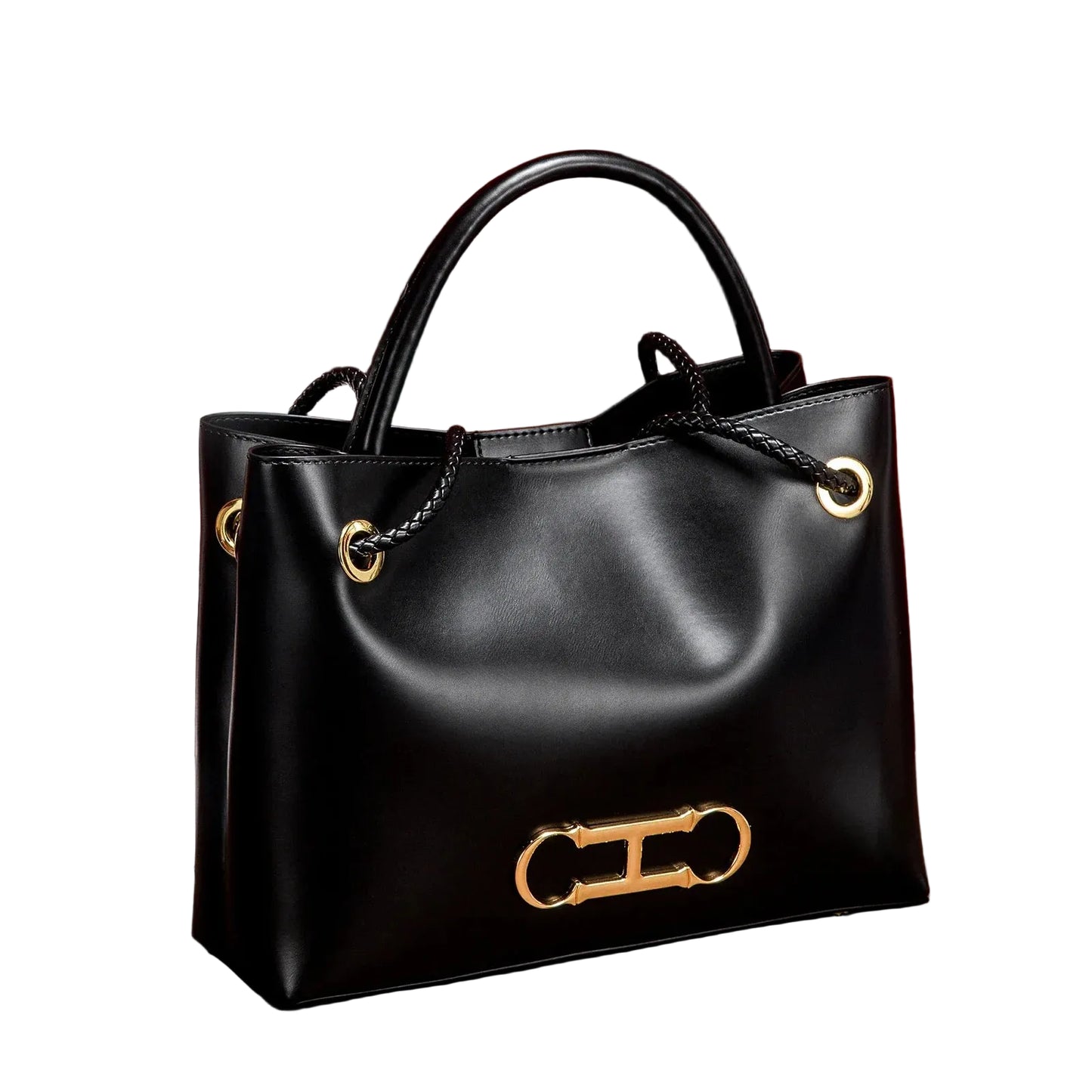 Black handbag with gold accents on a brown surface with a red curtain background