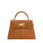 Brown leather handbag with gold hardware on a white background