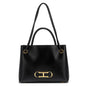 Black handbag with gold hardware on a white background
